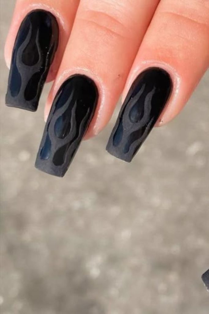 Smoky black flames on matte nails.