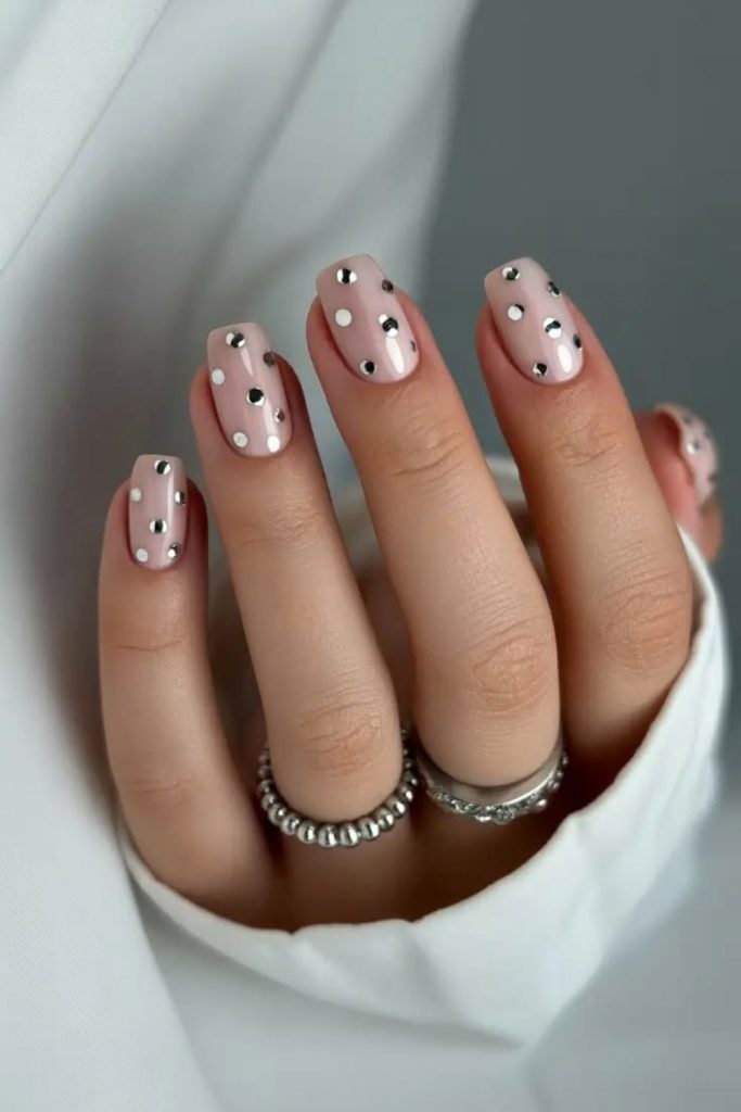 Scattered black and gold dots nails