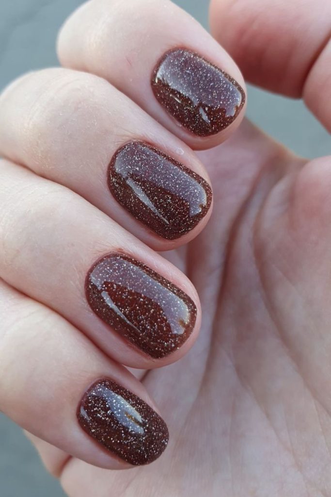 Chocolate brown nails with caramel specks.