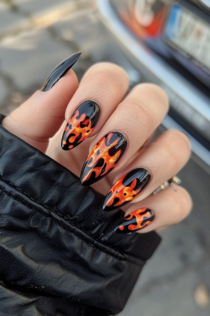 Neon orange flames on black nails.