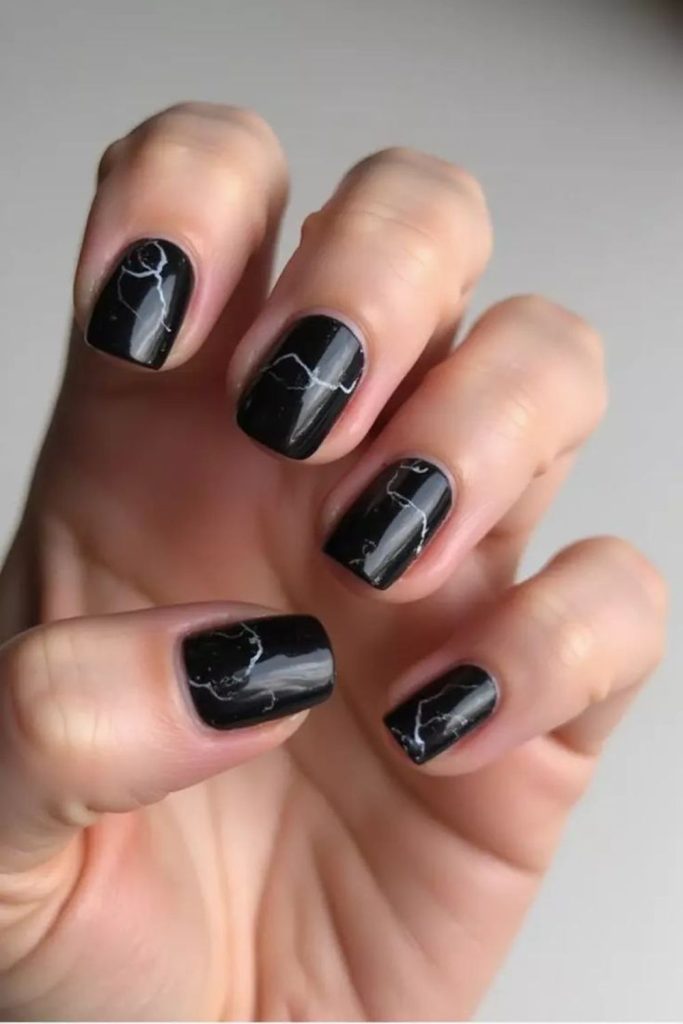 Black nails jagged with silver shards.