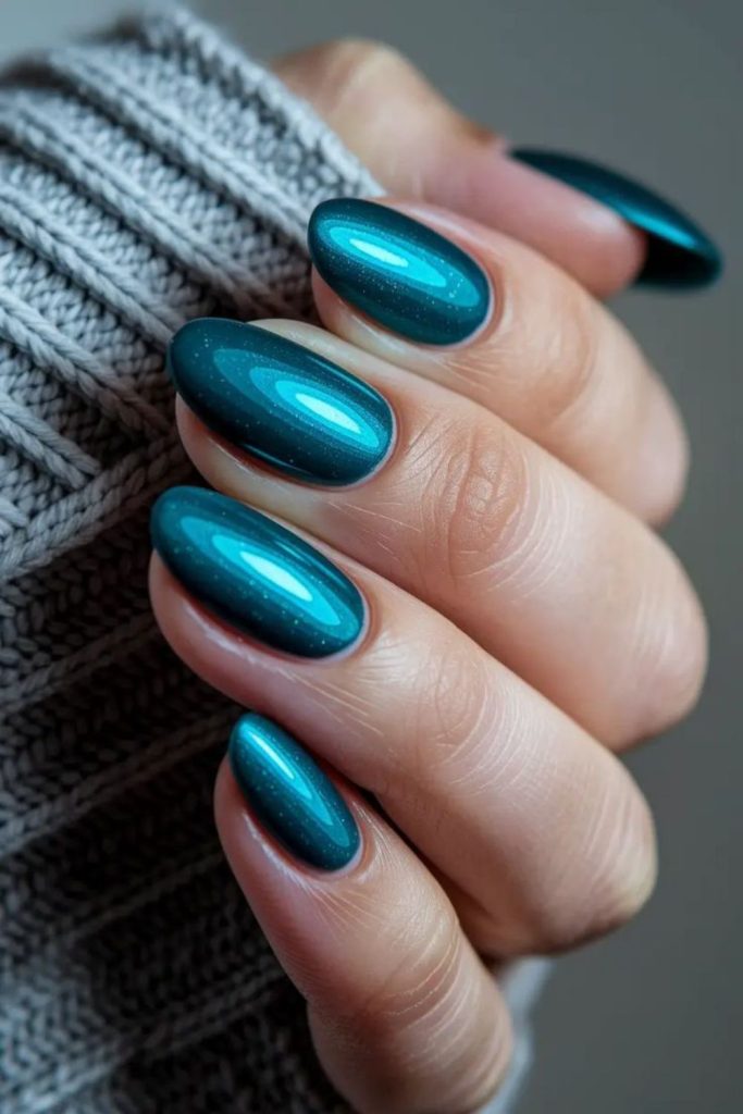 Teal nails shimmering like ocean waves.
