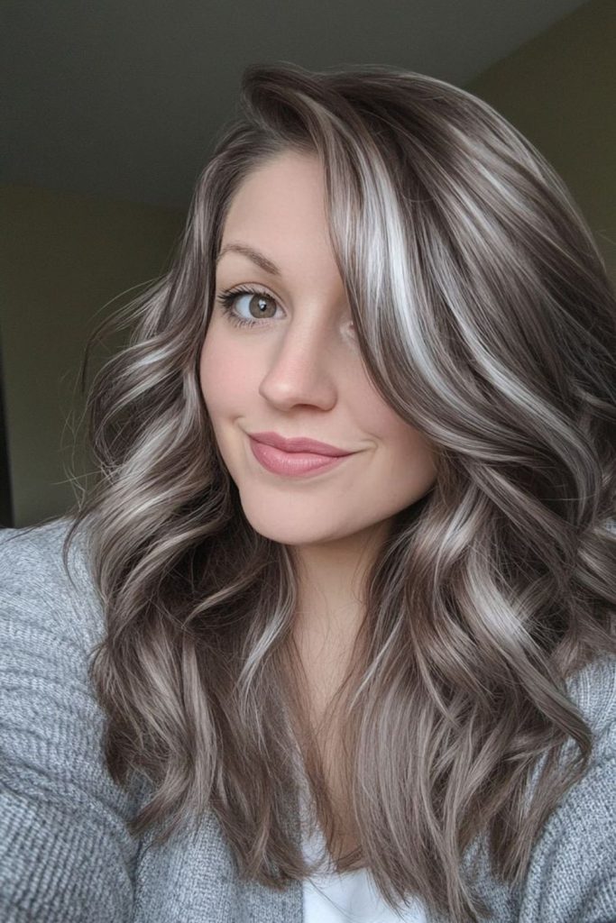 Pale smoky ash highlights dark hair.
