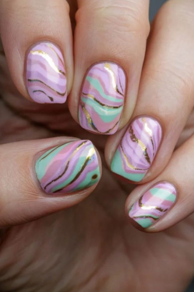 Swirled pastel cosmic patterns on nails