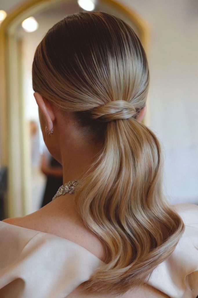 Low ponytail with sleek twisted detail.