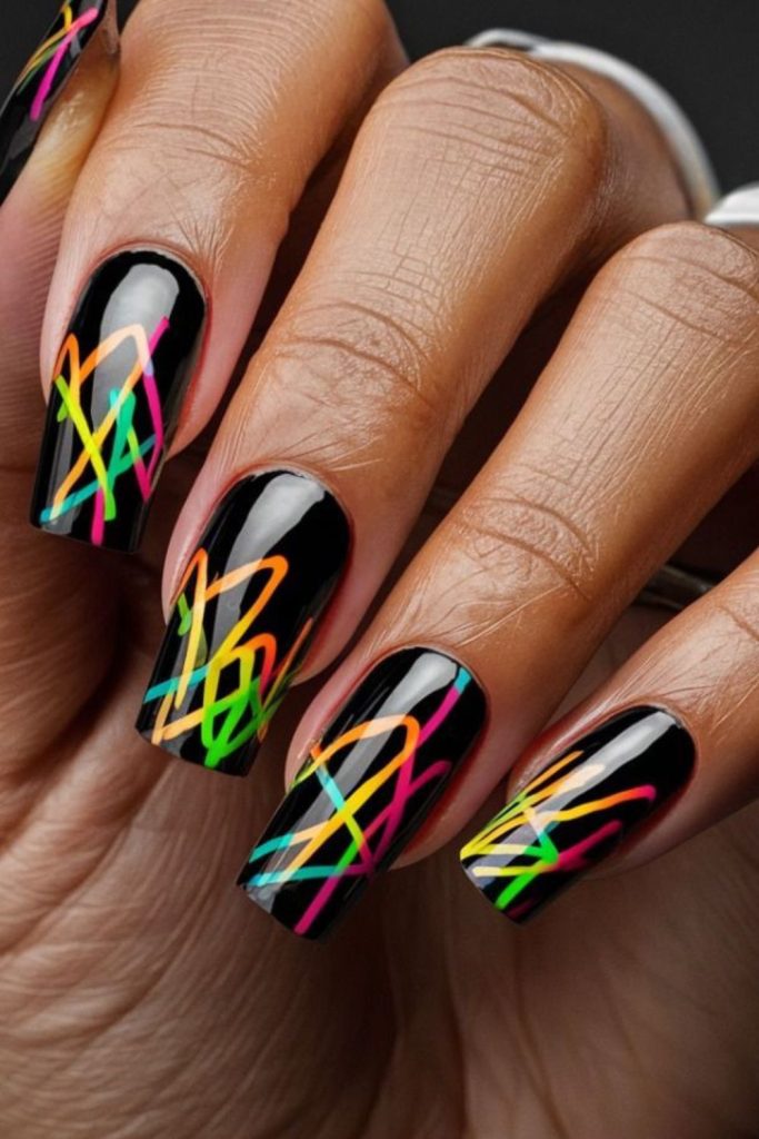 Matte black nails with jagged neon