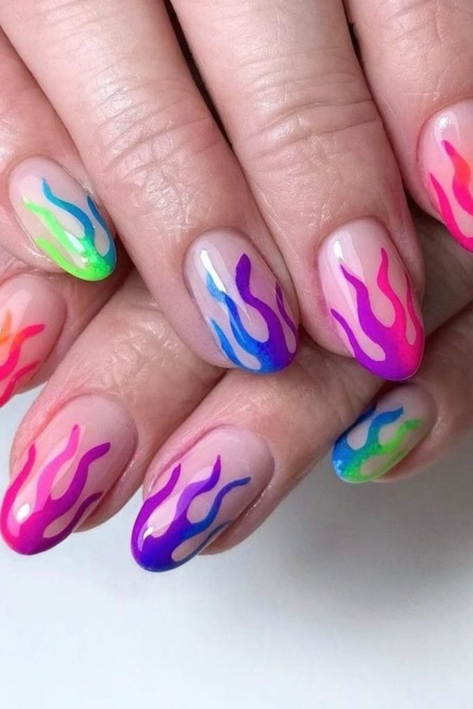 Rainbow flames on bright white nails.