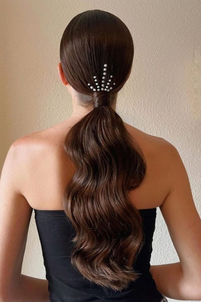 Sleek low ponytail accented with clips