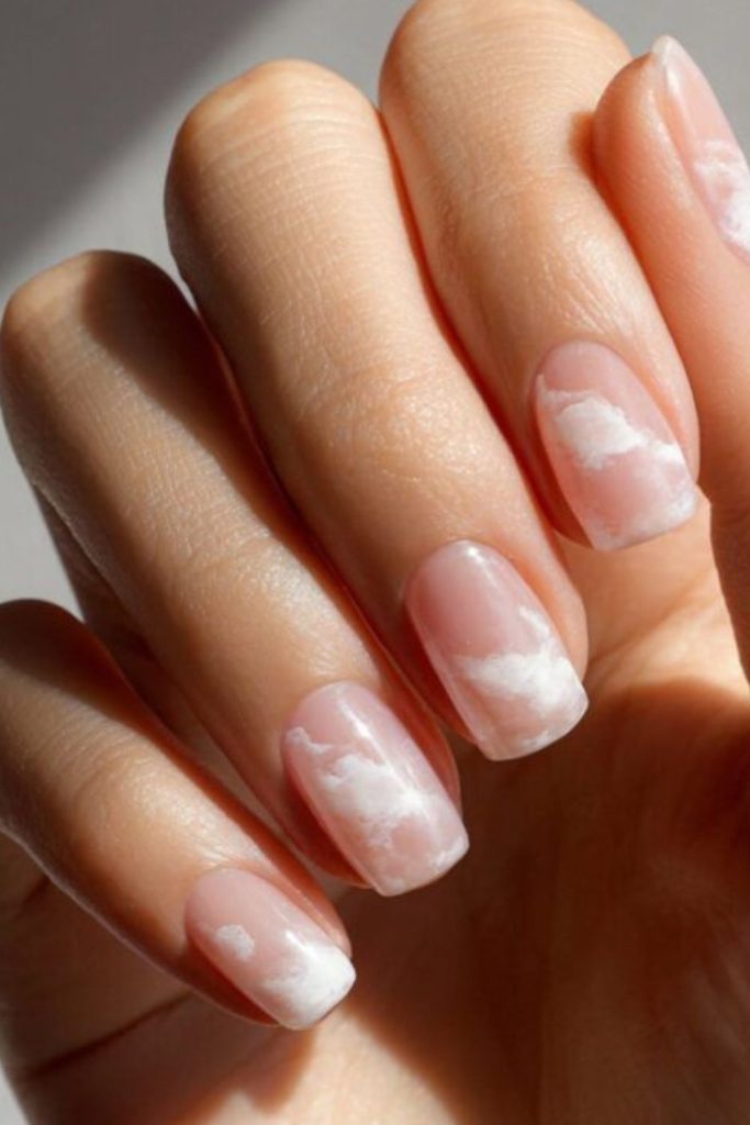 Blush nails with white clouds