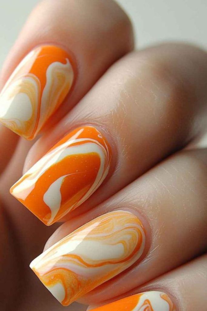 Orange yellow sun-inspired swirling nails