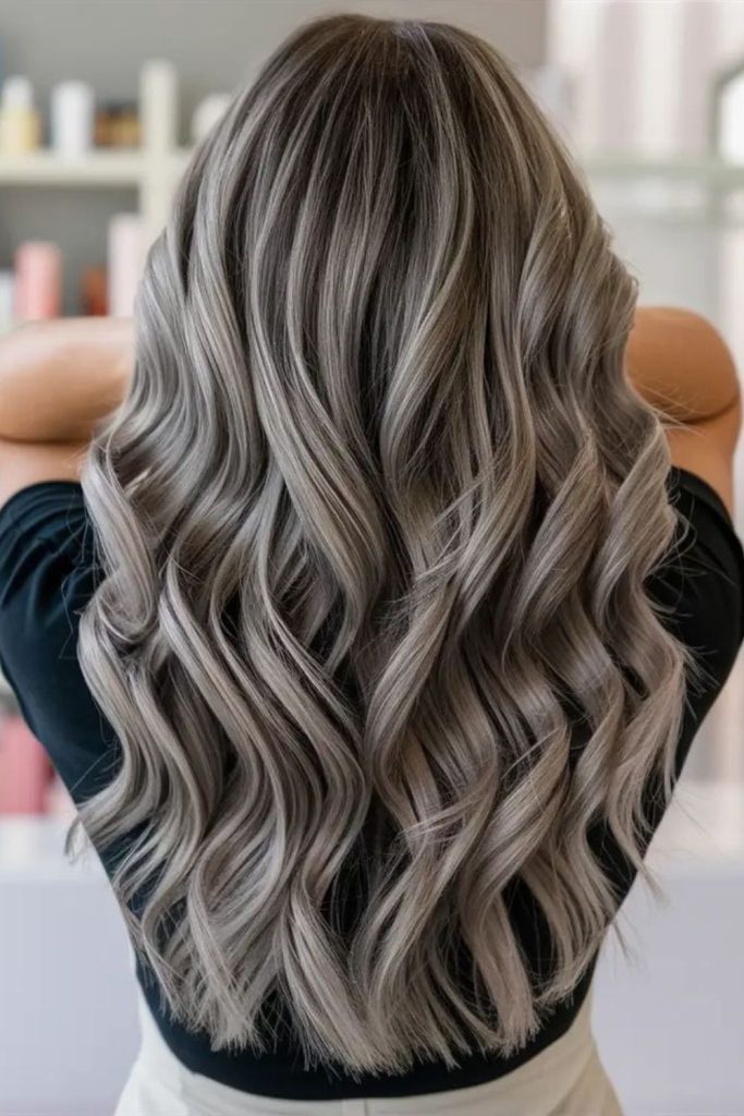 Blended ash highlights dark hair.