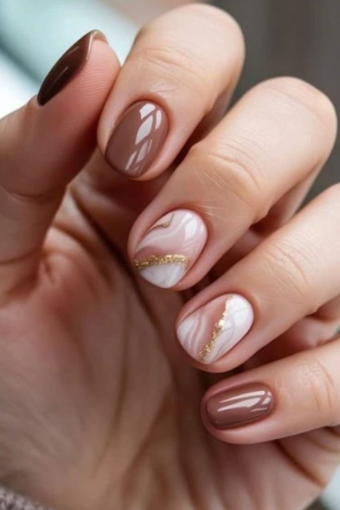 Creamy beige nails with coffee swirls.