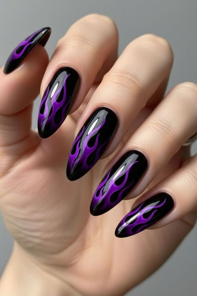 Purple flames on glossy black nails.