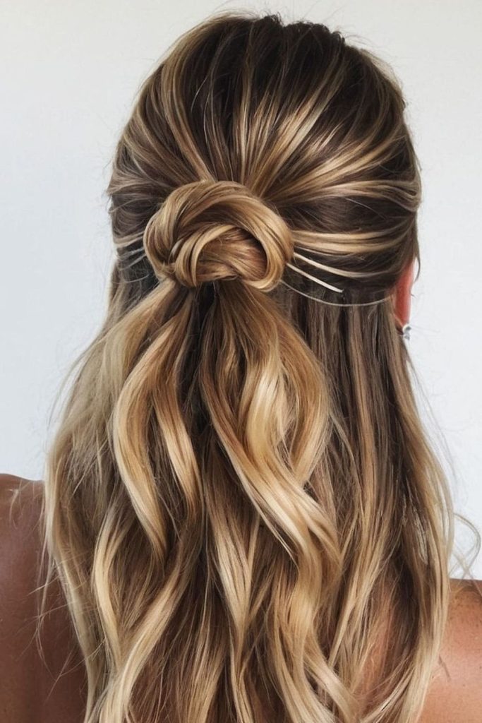 Half up knot relaxed pool hairstyle.