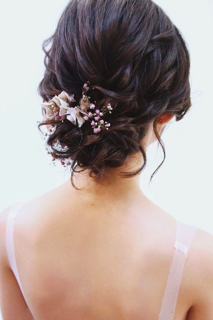 Loose bun blossom inspired soft updo