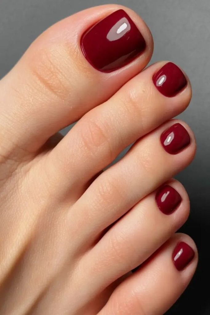 Deep cherry wine glamorous toenail design