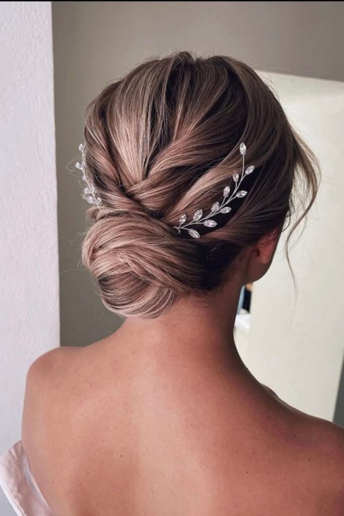 Crystal pin sleek low bun hairstyle