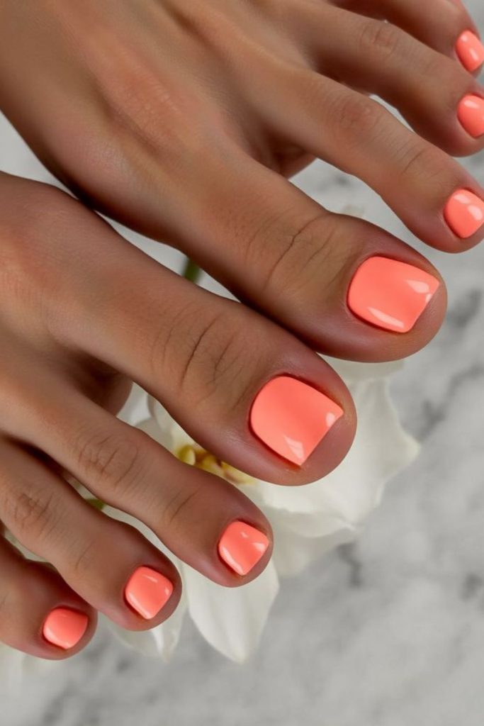 Bright coral tropical summer toenail style