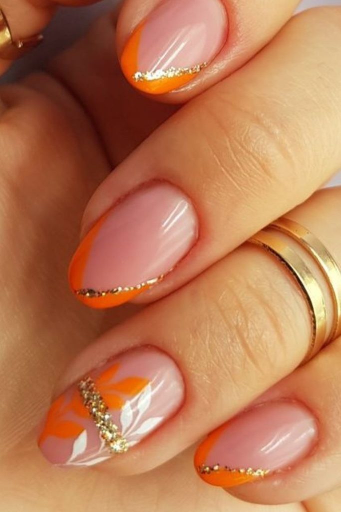 Golden lined orange chic modern nails.