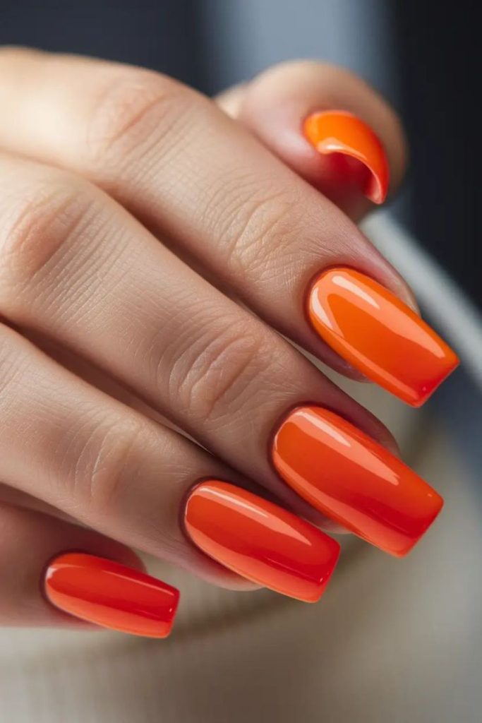 Neon orange glossy bold statement nails.