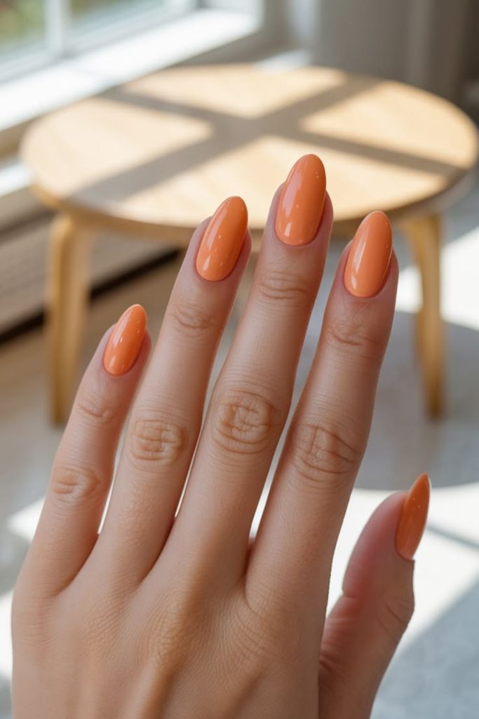 Orange sorbet glossy smooth vibrant nails.