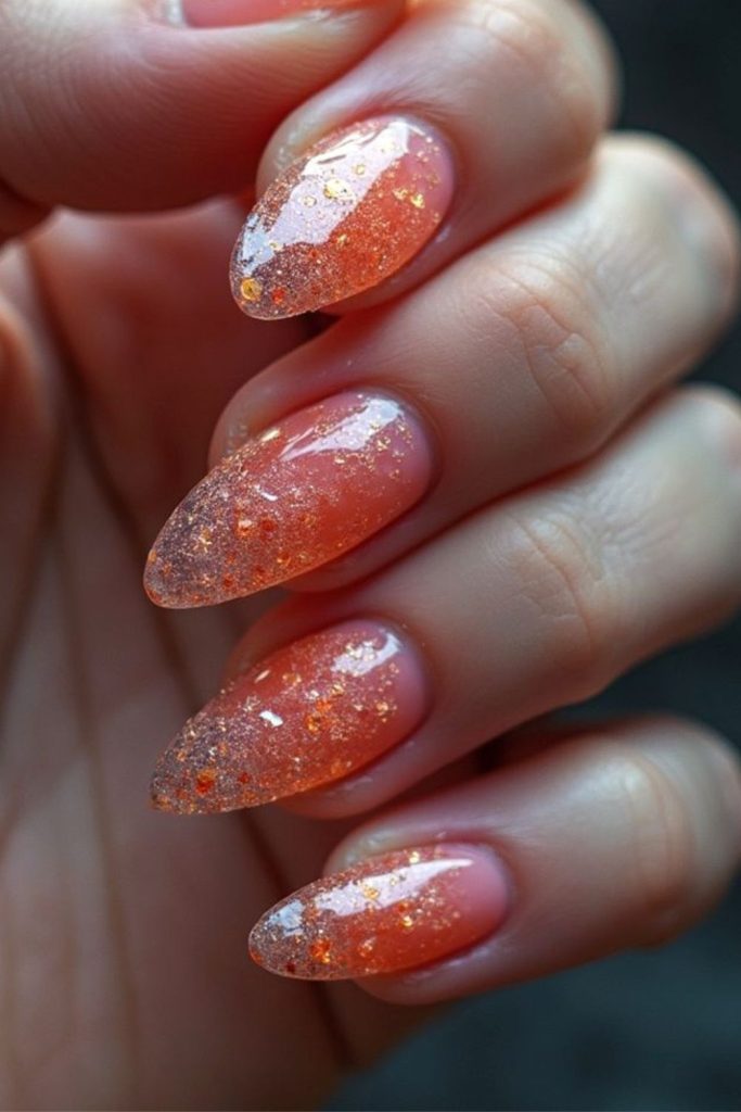 Orange stardust shimmer soft glowing nails.