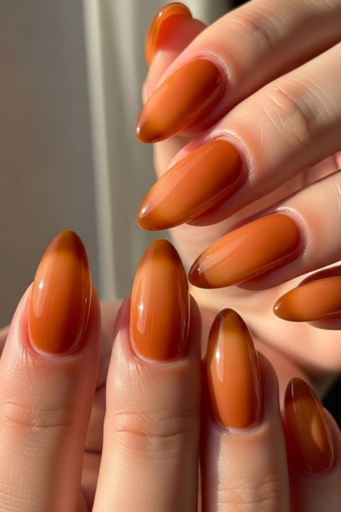 Rusty orange matte speckled earthy nails.