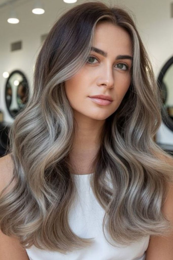 Long silver layers sleek flowing hair.