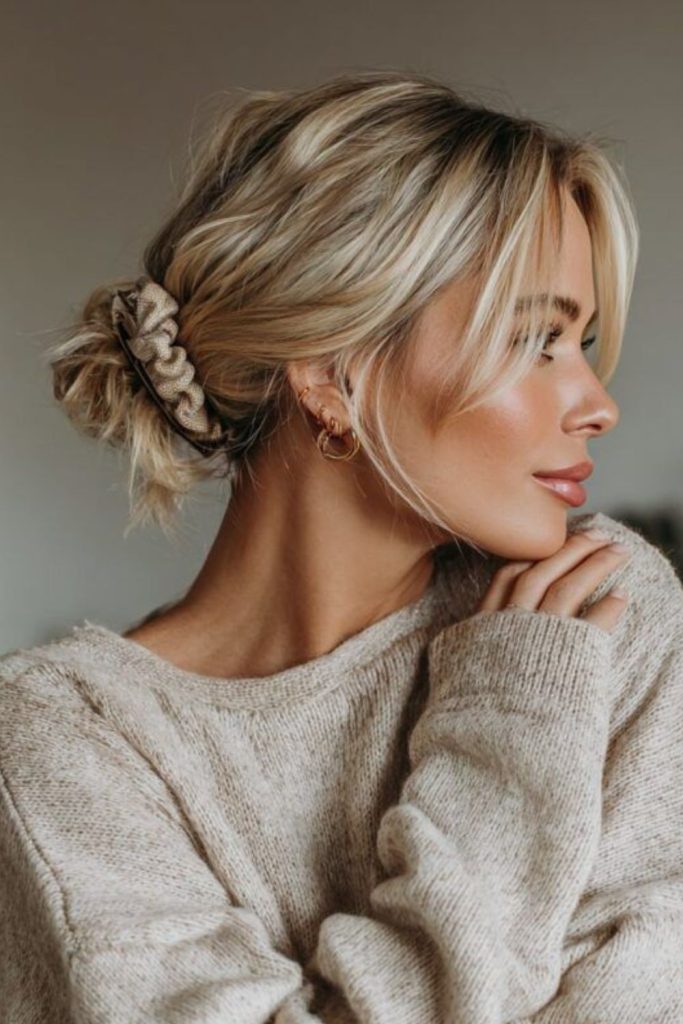 Silver moon loose bun with relaxed texture and soft wispy elegant strands.