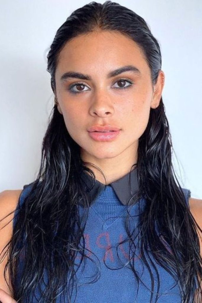 Slicked back wet glossy hair look.