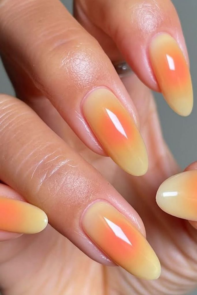 Mango fade soft matte orange nails.