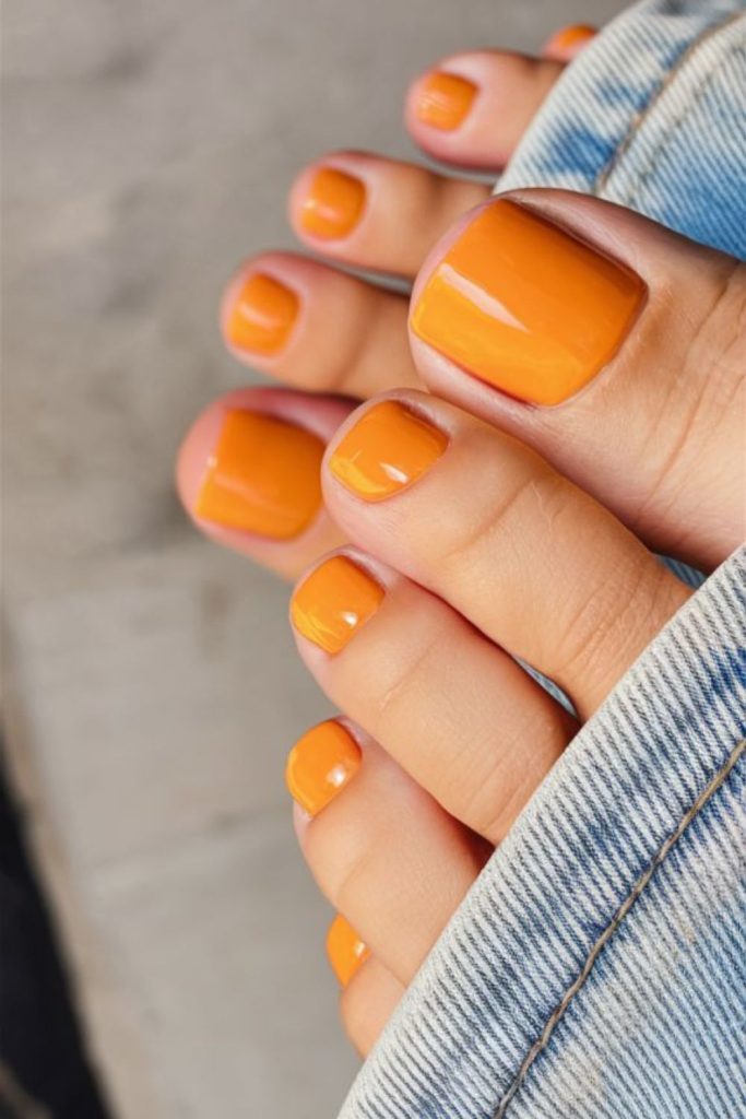 Vivid tangerine sunset toenail aesthetic style