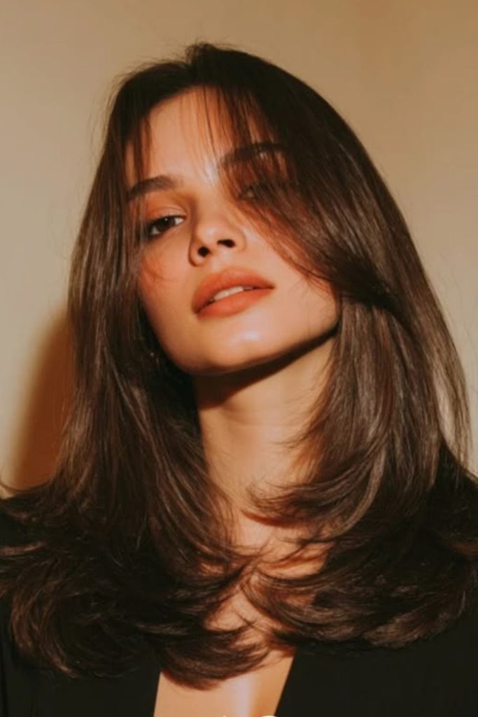 Curtain parted medium sleek flowing hairstyle