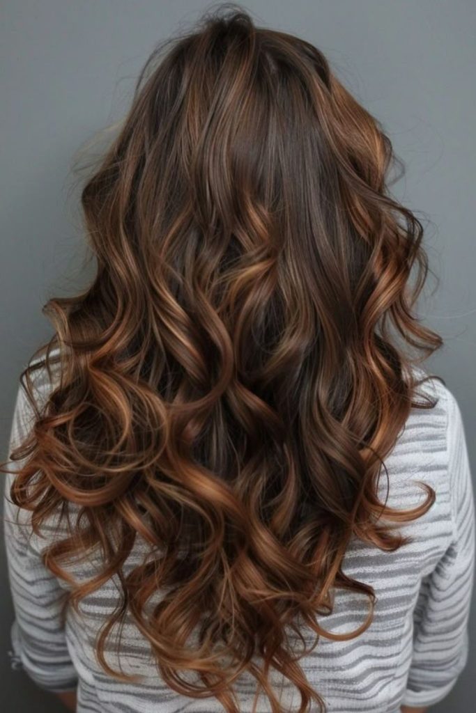 Amber curl cascade warm voluminous spirals