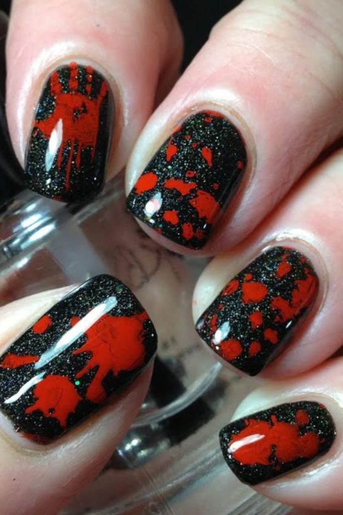 Black red splatter chaotic goth nails