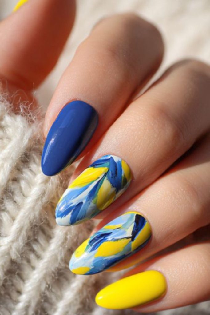 Blue nails with yellow ink splash art.