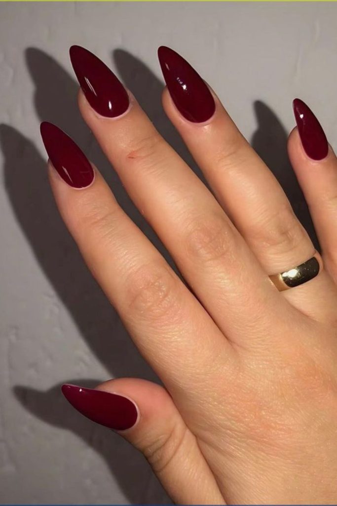 Deep cherry red glossy nails.