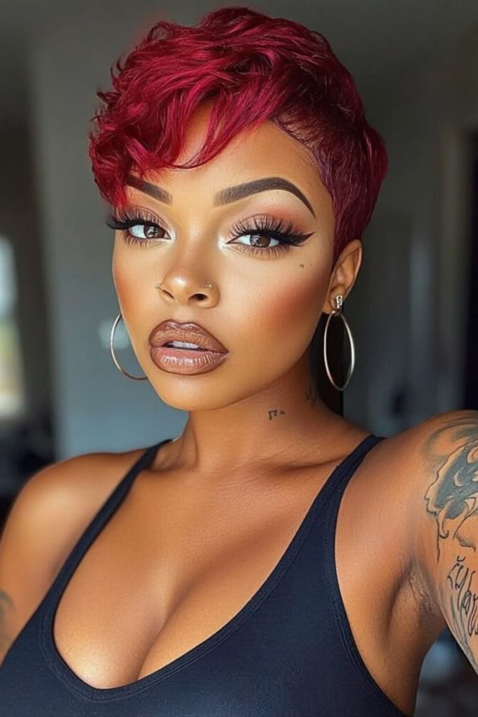 Cherry toned pixie cut with smoky layers and soft textured movement.