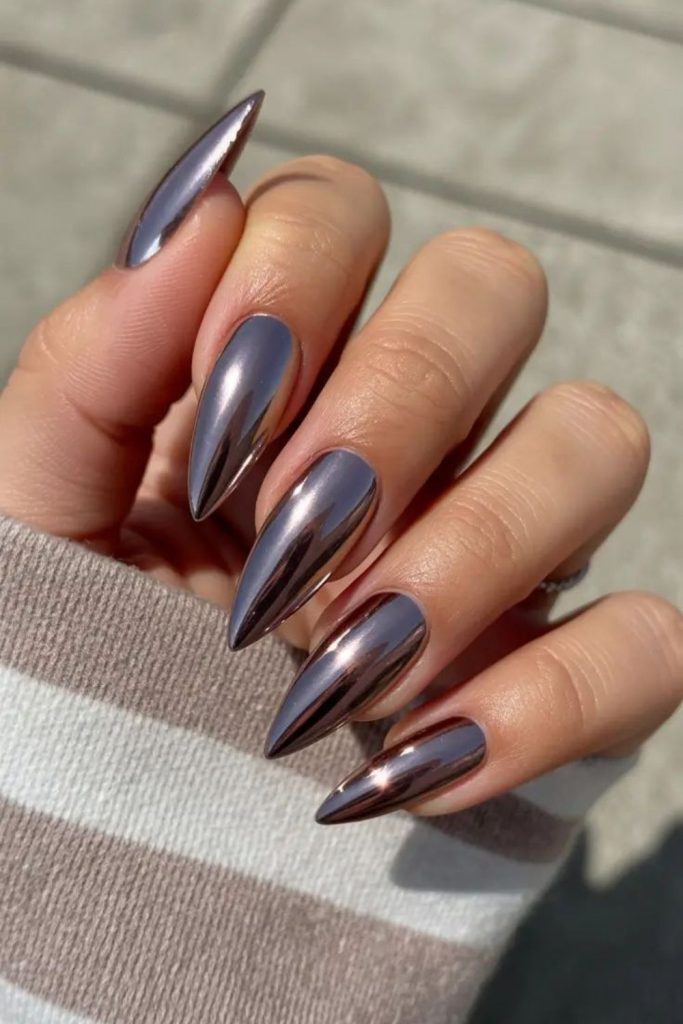 Shiny chrome almond baddie nails.