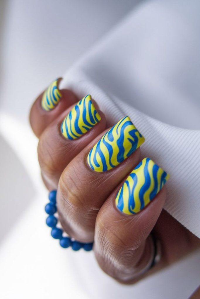 Blue nails with yellow aurora wave blend.