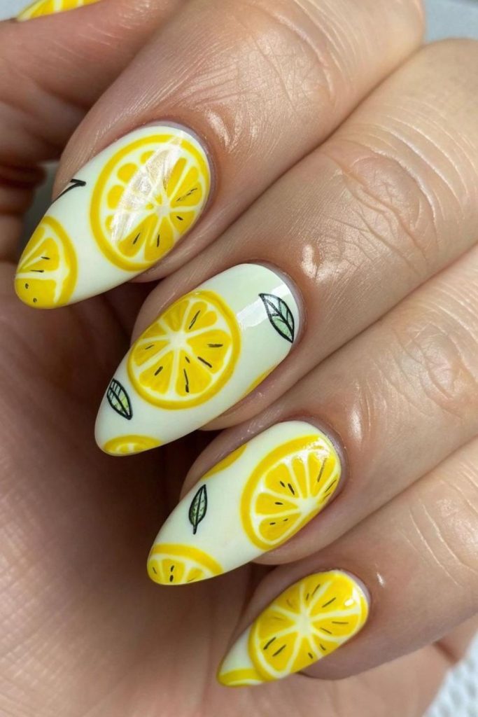 Fun citrus slice nail art with playful yellow pop art fruit themed detailing.