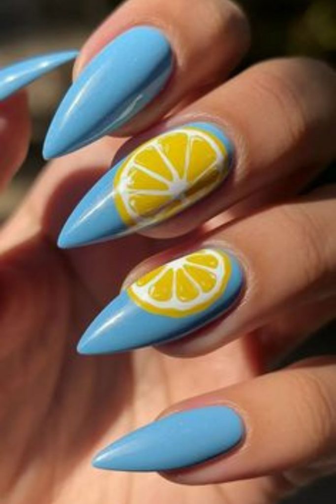 Blue nails with single yellow accent pop.
