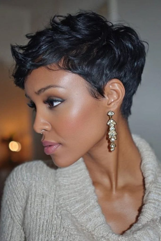 Ash grey pixie haircut with cosmic texture and soft airy layers.