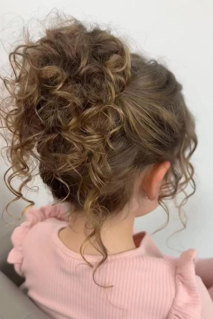 Fluffy high bun with looped curls