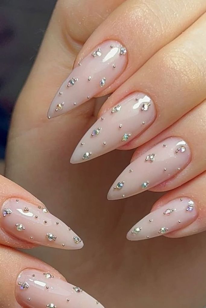 Nude crystal rhinestone baddie nails.