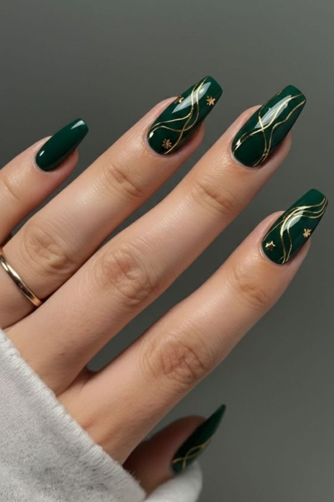 Emerald green graduation nails with gold.