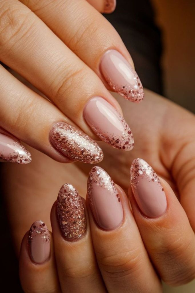 Rose gold glitter graduation nails.