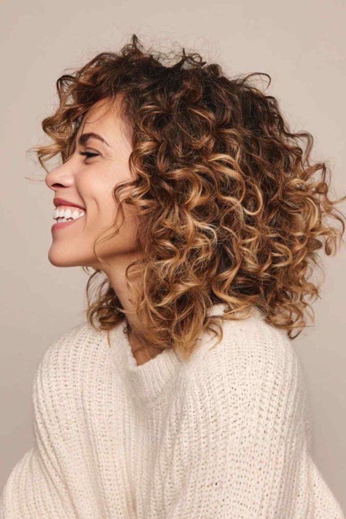 Natural volume hairstyle with strong presence.
