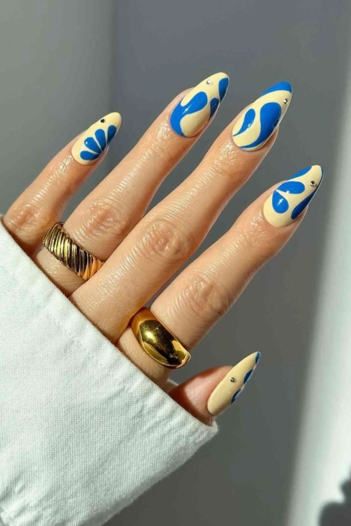 Ocean blue nails with yellow coral design.