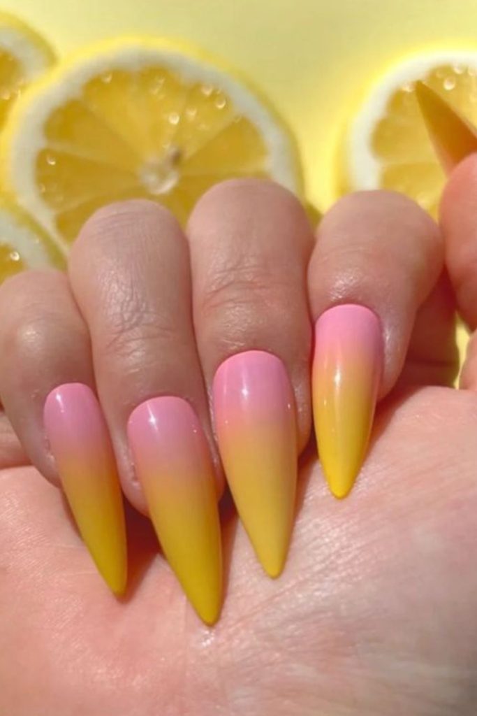 Flaming lemon gradient nails with warm orange glow fiery summer inspired tips.